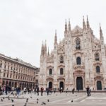 Milan cathedral (duomo di milano) with tourists and pigeons in the piazza del duomo.