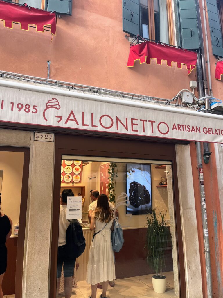 A small gelato shop in a light orange building called gelateria gallonetto