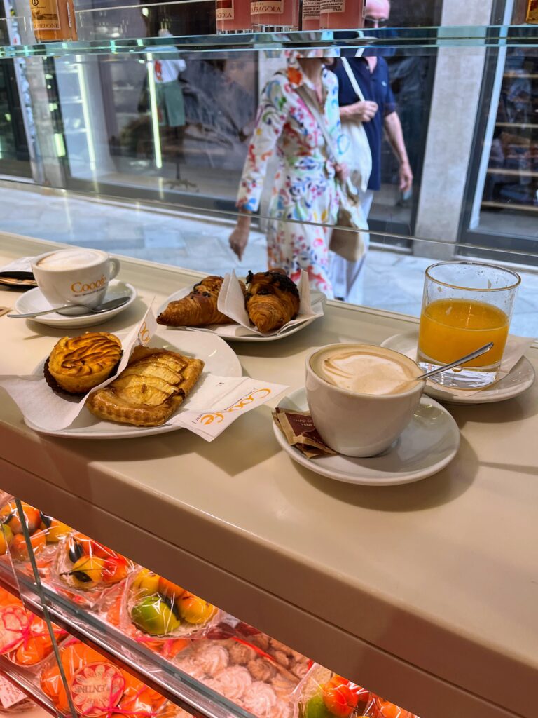 Coffee, pastries, and orange juice set on an elevated counter